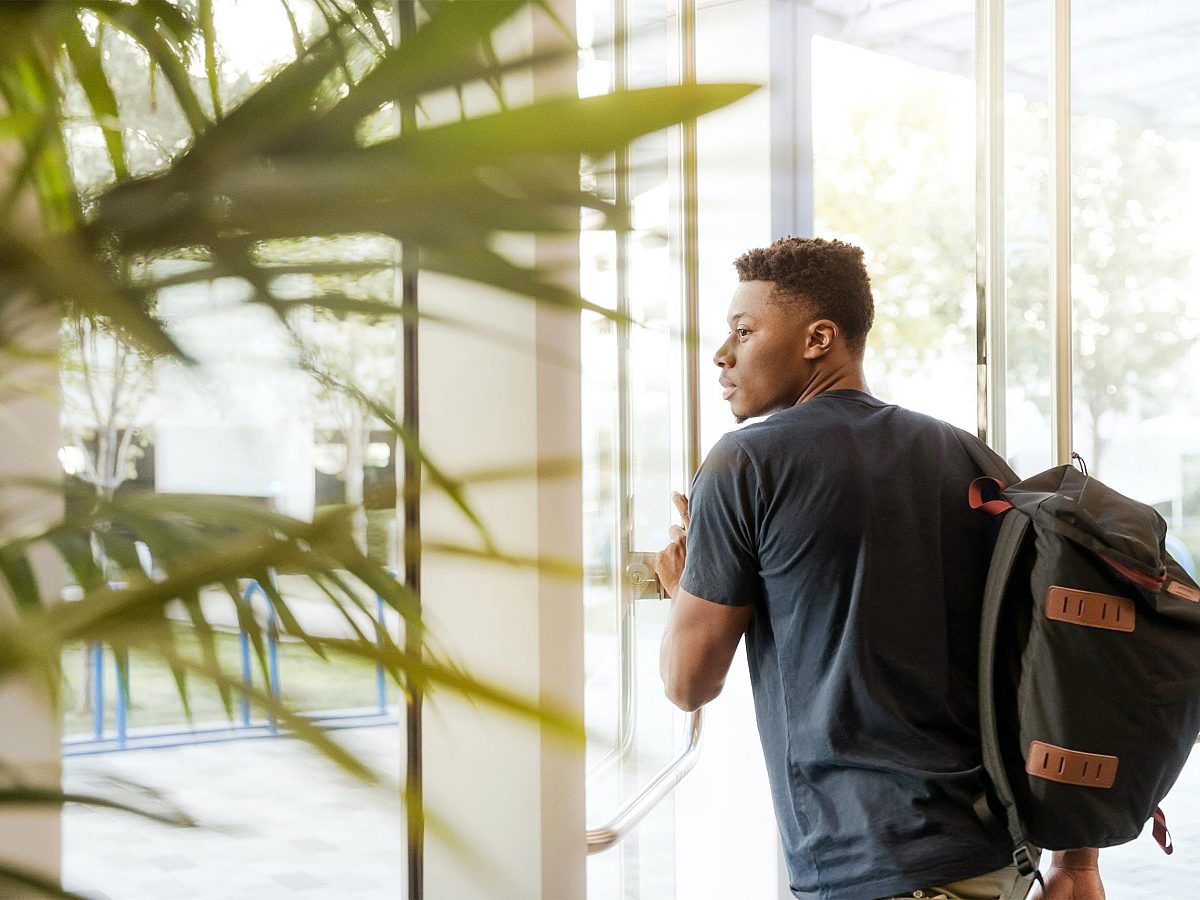 College Guy Walking Out of Building