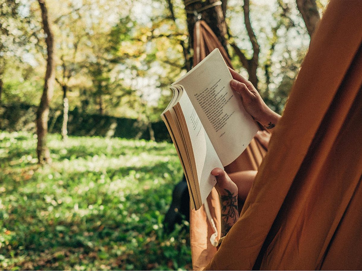 Person Reading Book in Hammock